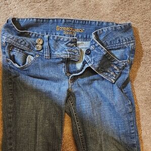 Streetwear Society Brand Bell Bottom Jeans With An Assymetrical Strap Button Up